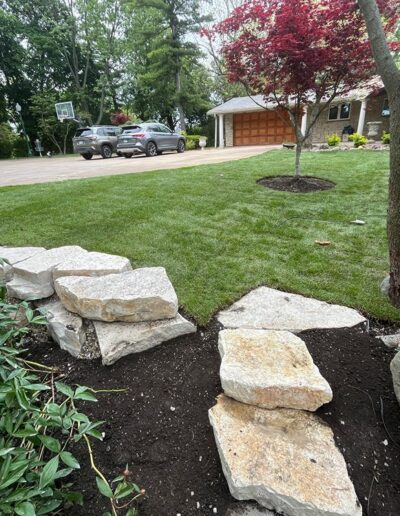 Beautifully landscaped yard with stone pathways by Weadickbros Landscape Design & Build.