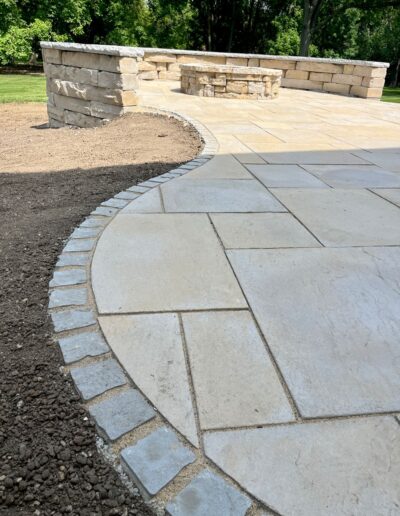 Elegant stone patio with curved edges by Weadickbros Landscape Design & Build