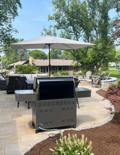 Elegant outdoor patio with seating and grill by Weadickbros Landscape Design & Build